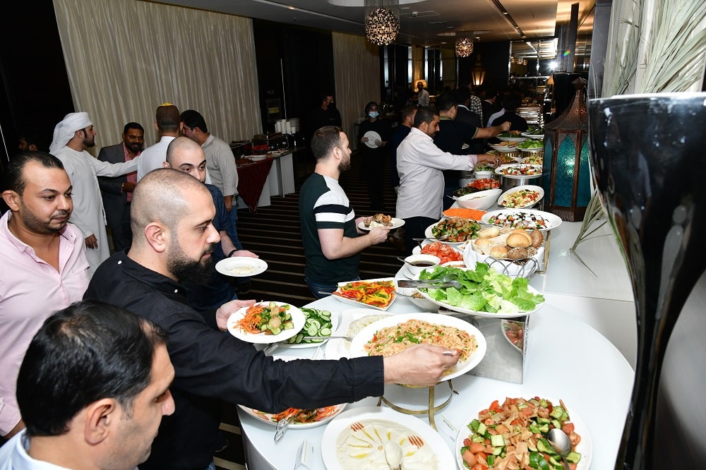 Two handsome bald men at CTC customer iftar event