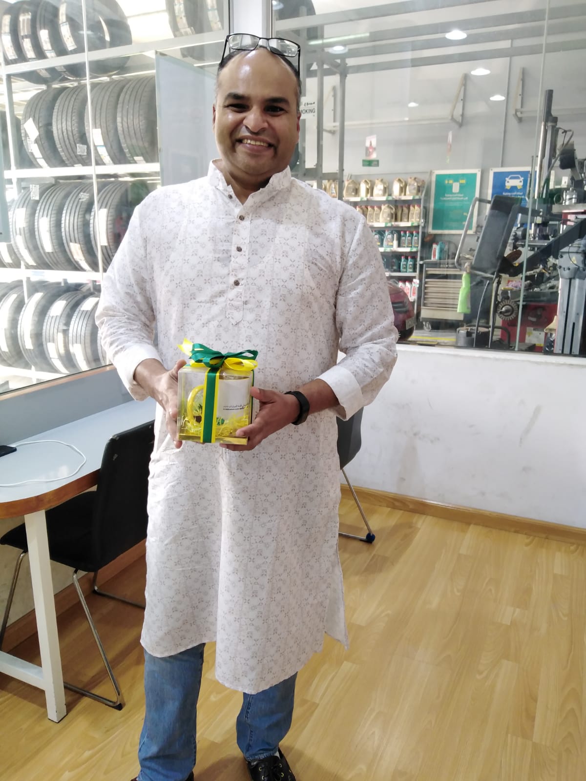 Blad man in kurta with gift pack