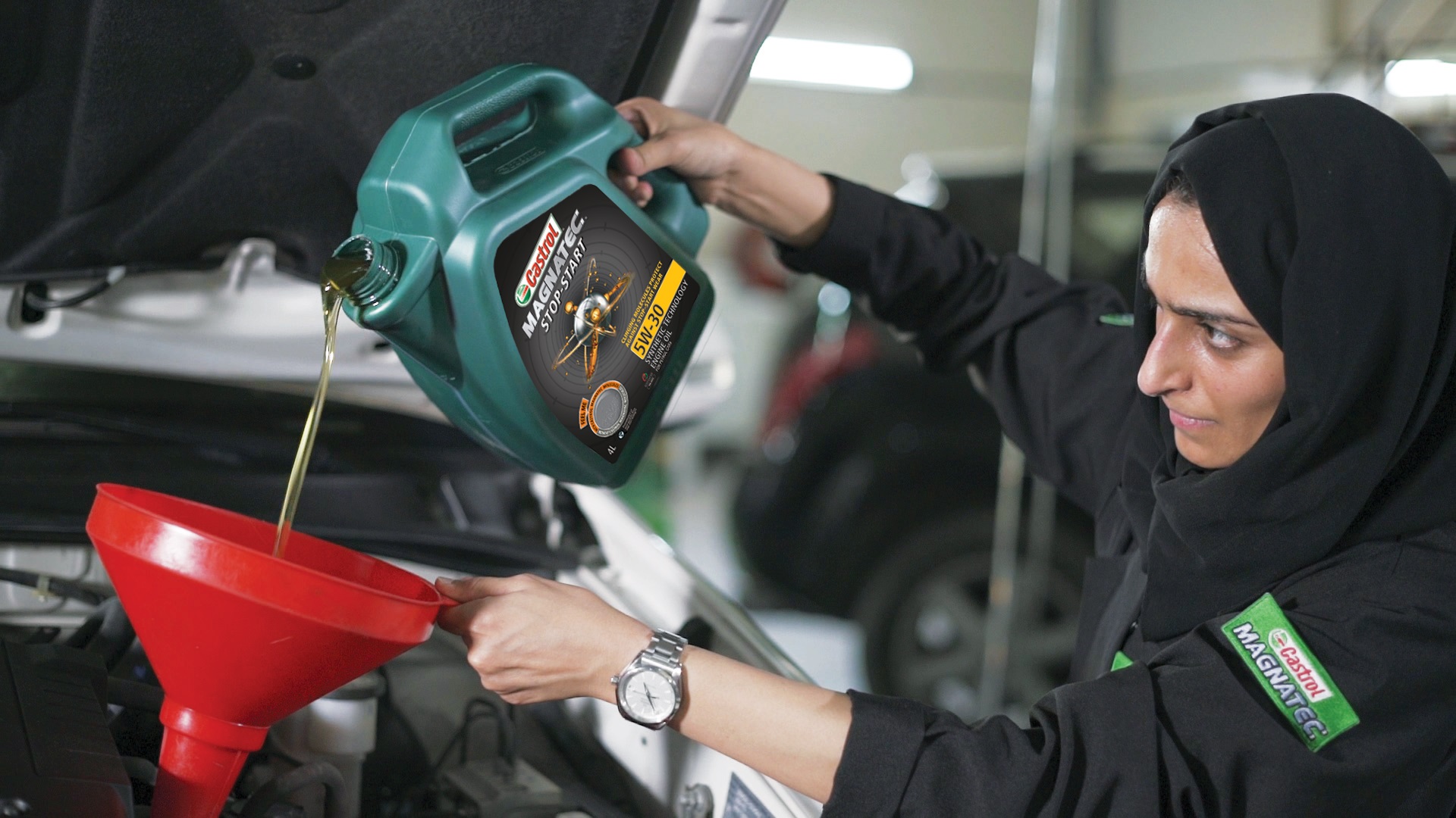 Brave Huda Al Matroushi pouring Castrol Magnatic oil