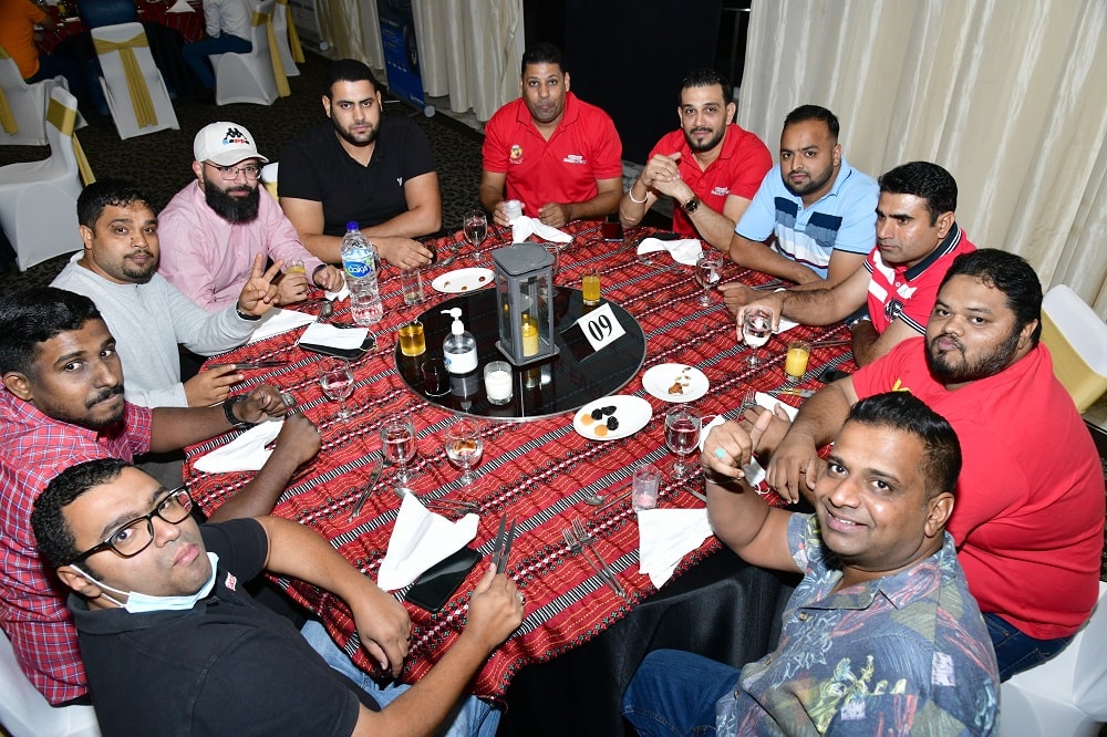 Team members sitting in a group before iftar