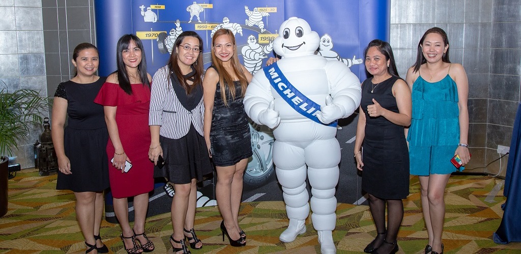 Very beautiful girls with Michelin statue