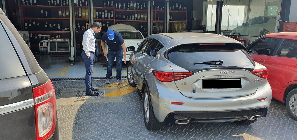 Mechanic explaining a corporate man about the tyre safety