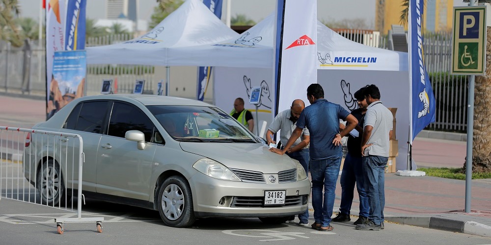 Silver car tyre checking by some professional