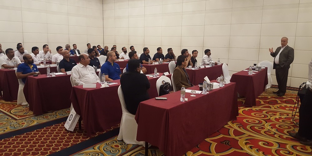 Participants listening carefully sitting on red table