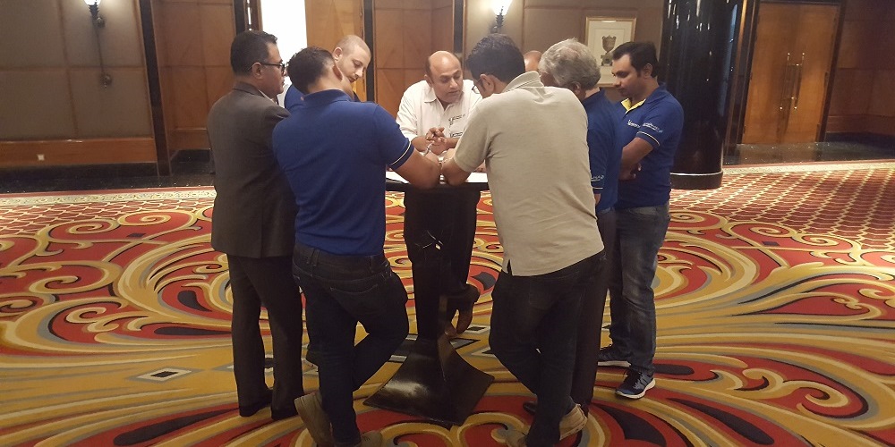 People stand around the round table